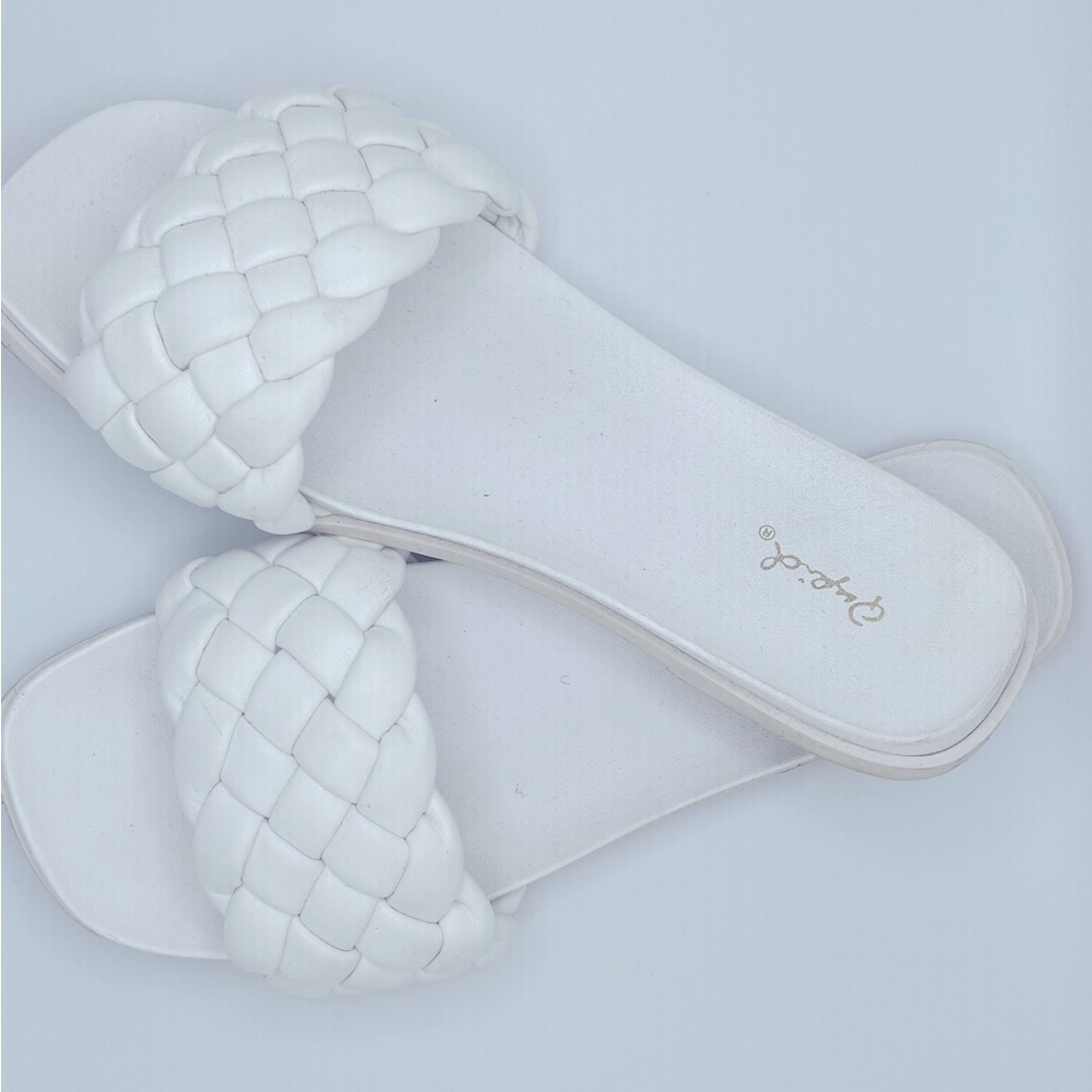 White braided flat sandals in various sizes